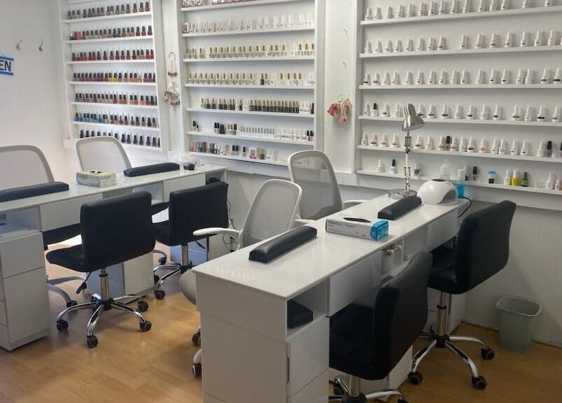 Modern nail salon interior at Rejoice Nails X Spa, Belleville, Ontario, CA, showcasing manicure stations.