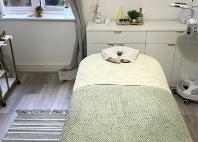 Tranquil treatment room at Reenas Touch, London, England, GB, featuring a cozy massage table and serene decor.