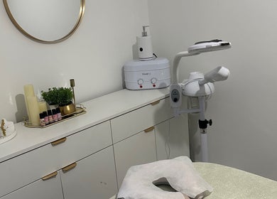 Calm treatment room at Reenas Touch, London, England, GB with elegant decor and beauty equipment.