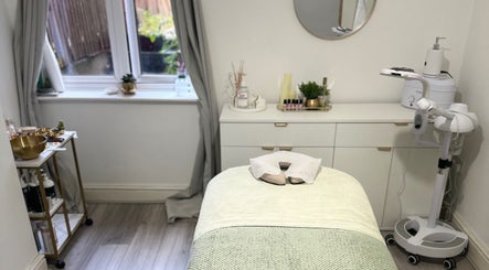 Relaxing treatment room at Reena’s Touch, London, England, GB, featuring a massage table and soothing decor.