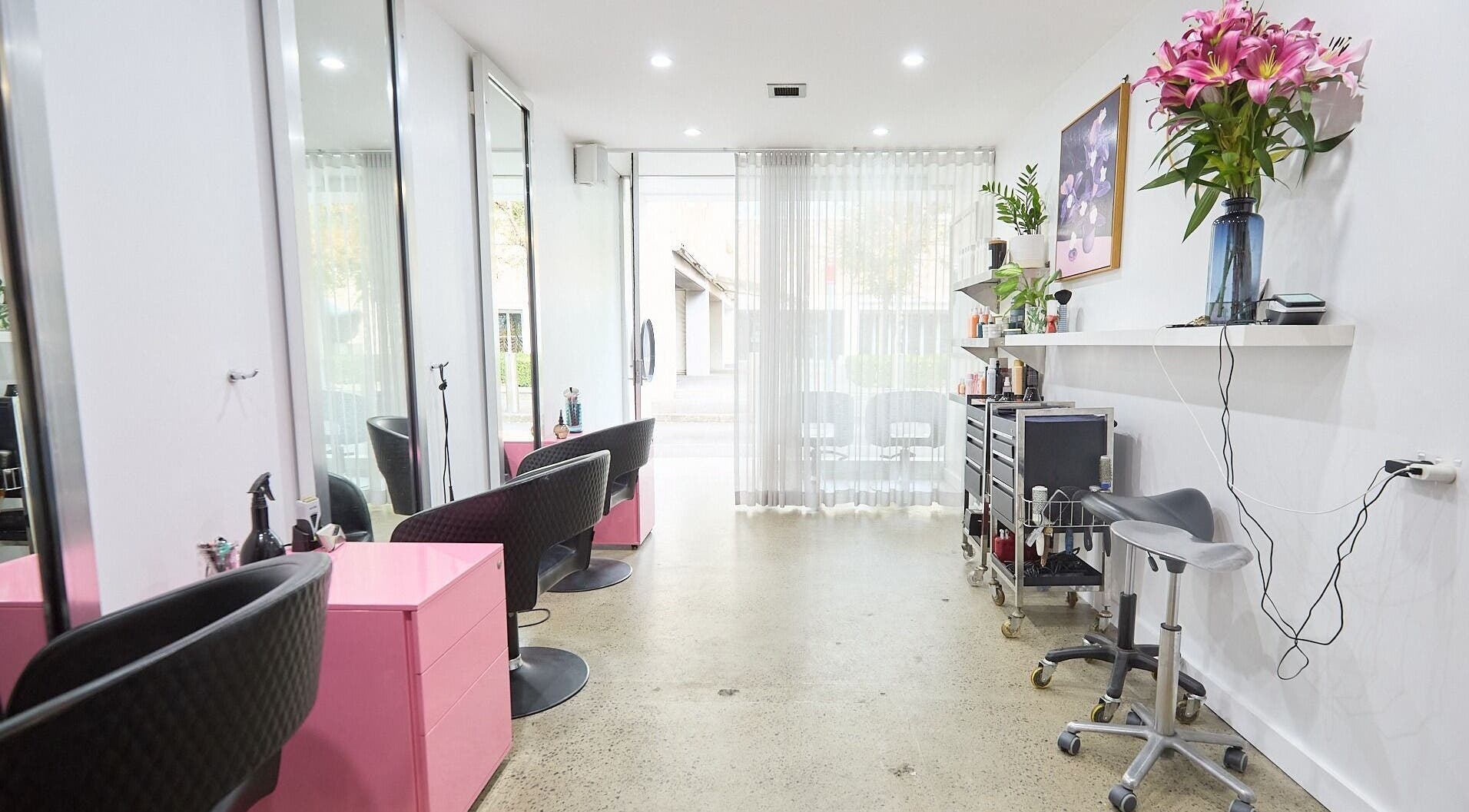 Modern salon at Jeremy The Hairdresser, Darlinghurst, New South Wales, AU, with sleek design and vibrant flowers.
