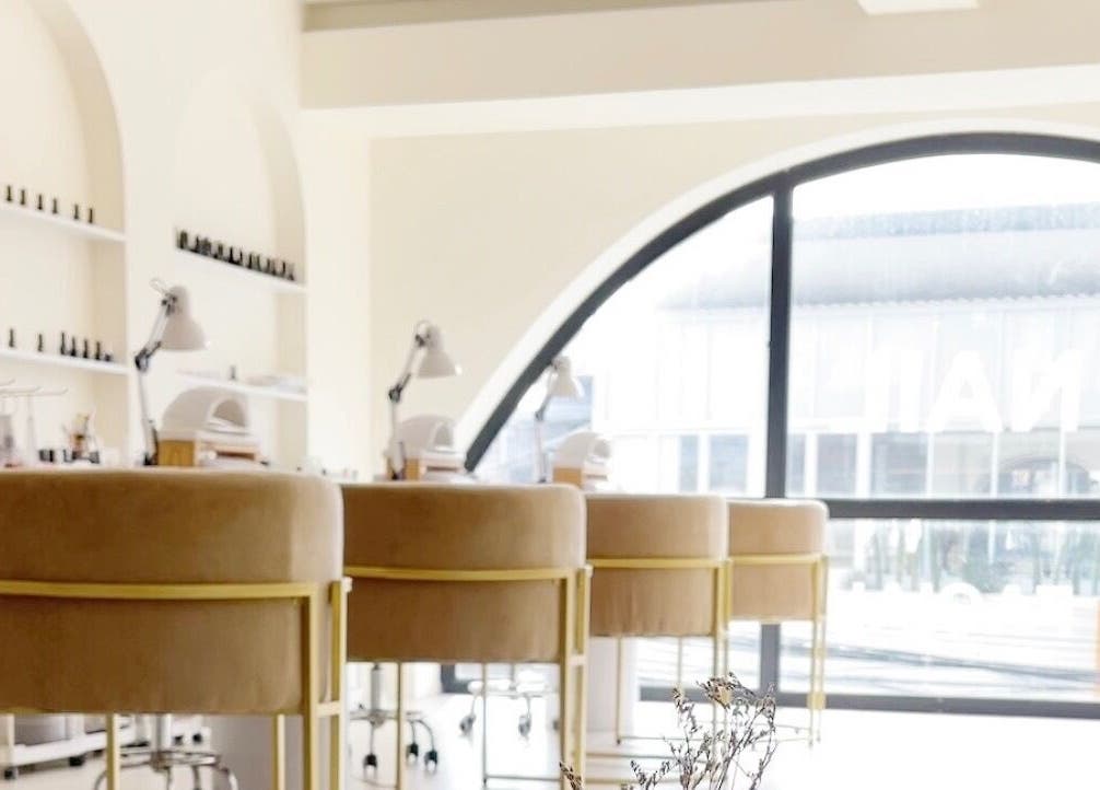 Chic nail studio at Aether Beauty in Bali. Modern design with comfy chairs and natural light.