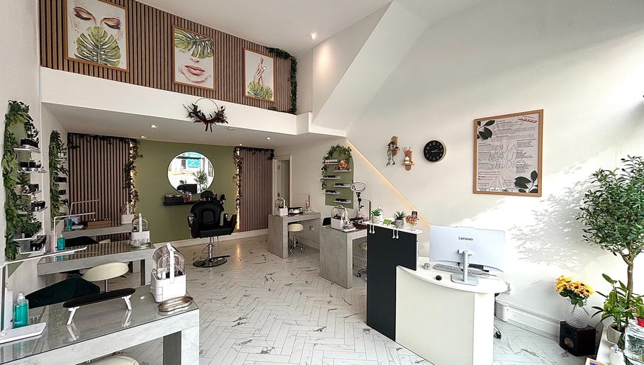 Chic interior of Dua Beauty Studio, Brighton, England, GB with modern design and lush greenery.