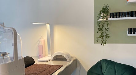 Cozy treatment area at Dua Beauty Studio, Brighton, England, GB. Features a lamp, chair, and beauty tools.