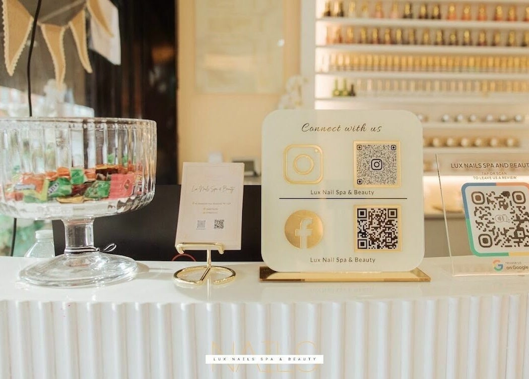 Lux Nail Spa & Beauty front counter with QR codes in London, England, GB.