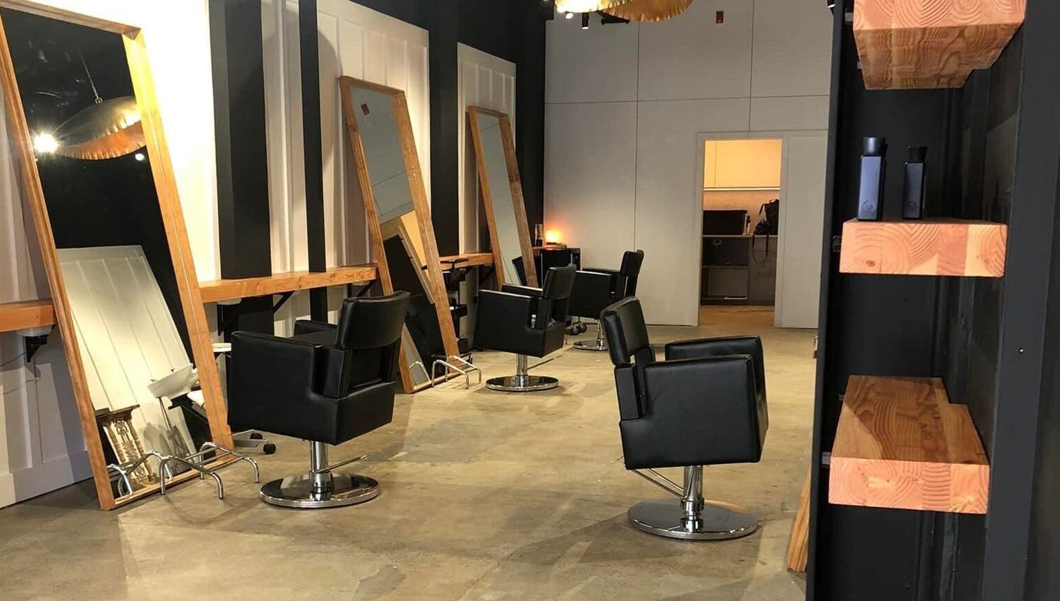 Modern salon chairs and mirrors at Rah in Hastings, Hawke's Bay, NZ, offering a contemporary beauty experience.