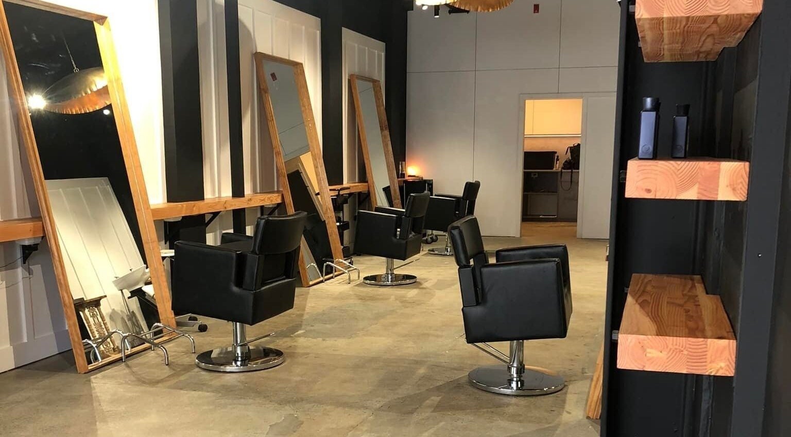 Modern salon chairs and mirrors at Rah in Hastings, Hawke's Bay, NZ, offering a contemporary beauty experience.