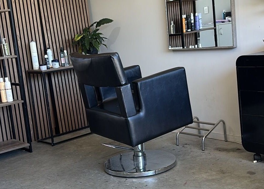 Modern salon chair at Rah, Hastings, Hawke's Bay, NZ, surrounded by stylish shelves and beauty products.
