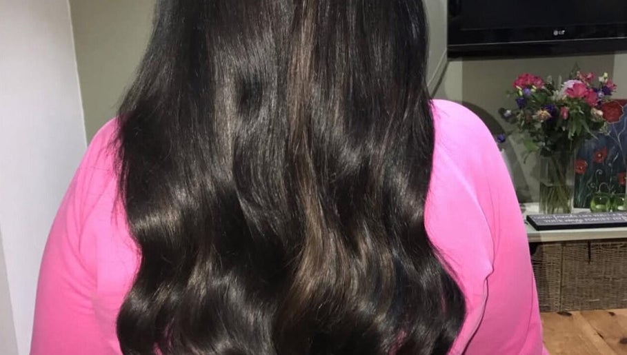 Shiny, smooth black hair styled in waves at Dollified Hair & Beauty, England, England, GB.
