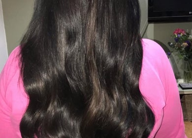 Shiny, smooth black hair styled in waves at Dollified Hair & Beauty, England, England, GB.