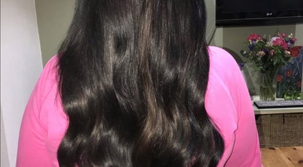 Shiny, smooth black hair styled in waves at Dollified Hair & Beauty, England, England, GB.