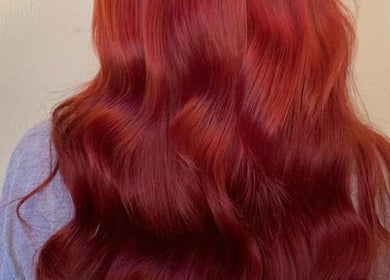 Vibrant auburn wavy hairstyle at Dollified Hair & Beauty, England, England, GB.