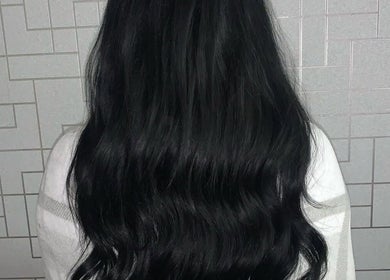 Long, silky black hair styled in waves at Dollified Hair & Beauty, England, England, GB.