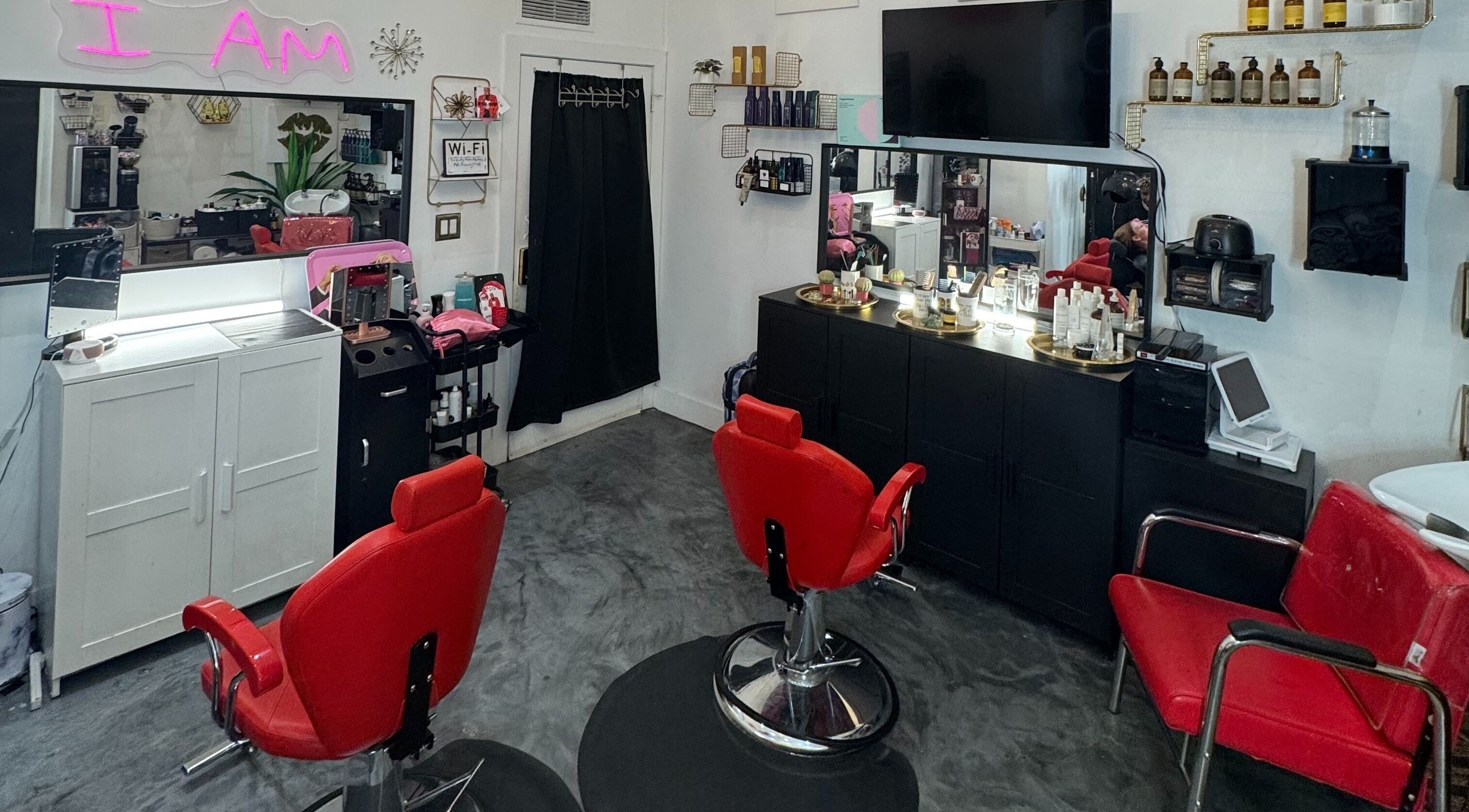 Flawless Lounge MIA beauty salon interior with vibrant red chairs in Miami, Florida, US.