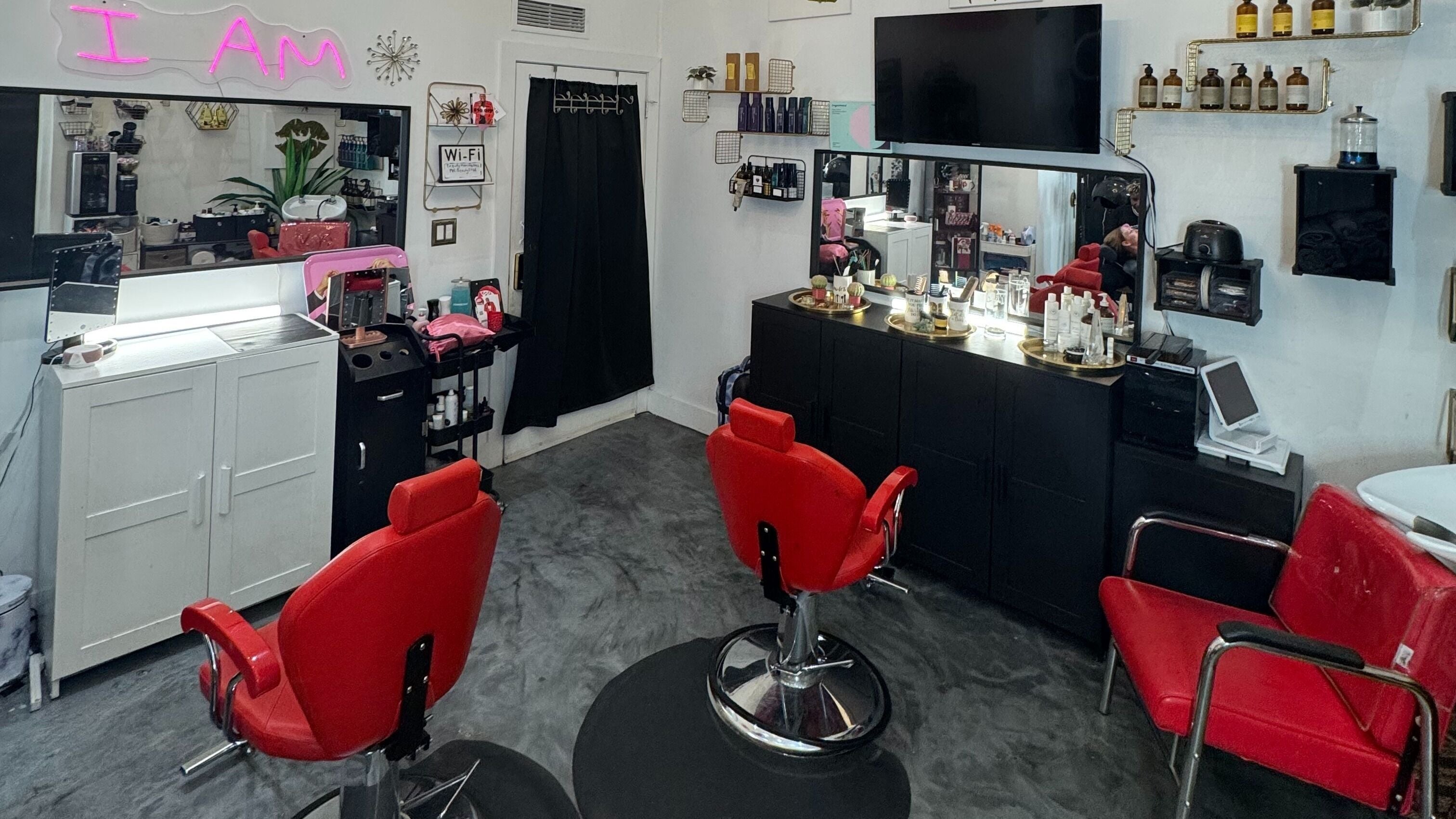 Flawless Lounge MIA beauty salon interior with vibrant red chairs in Miami, Florida, US.
