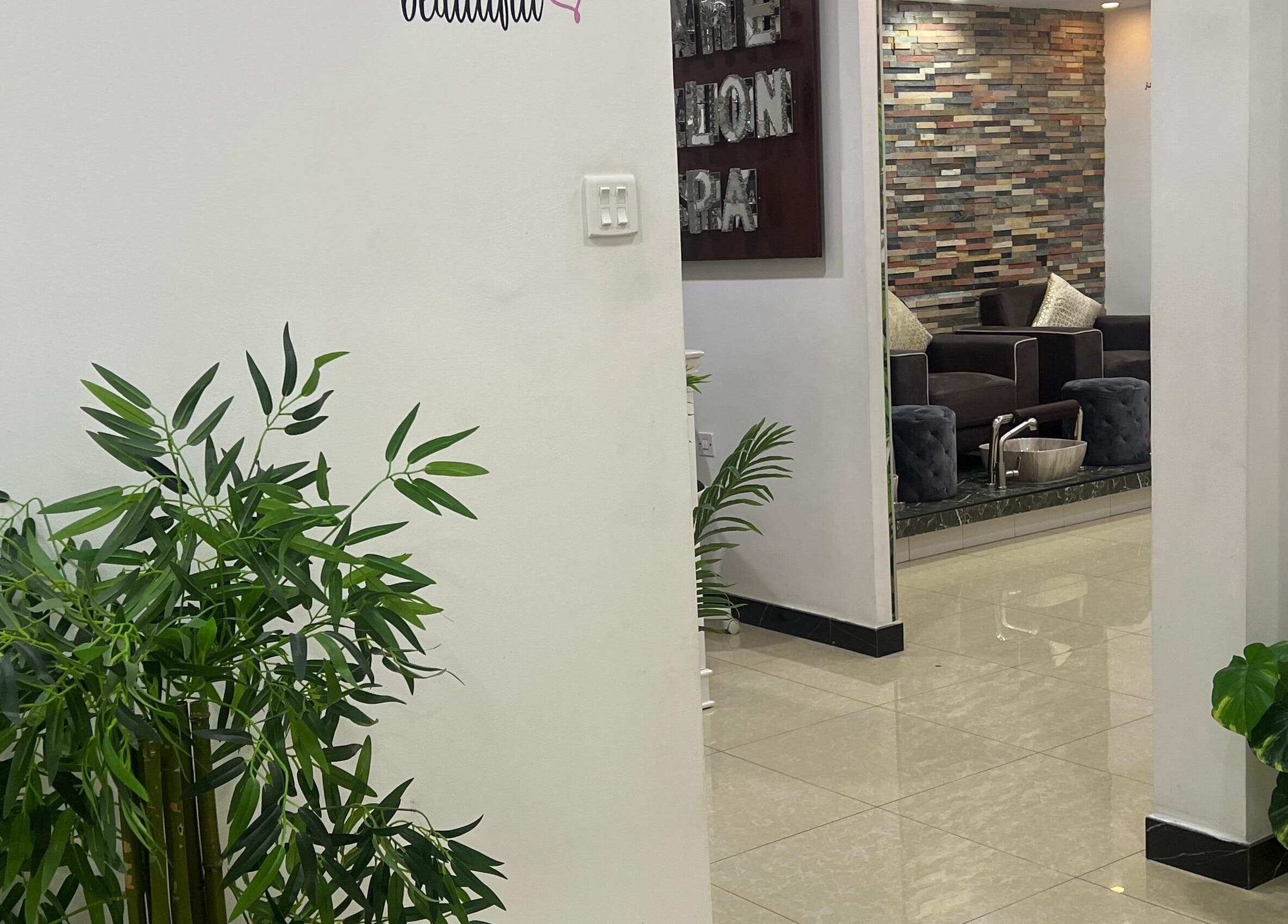 Inviting interior of Dame Salon & Spa in Muharraq Governorate, BH with lush greenery and comfortable seating.