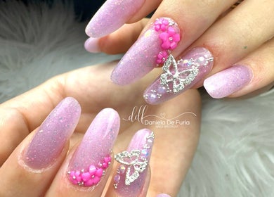 Design unghie rosa glitterate con decorazioni a farfalla da Daniela De Furia Nails Specialist, Casalgrande, Emilia-romagna, IT.