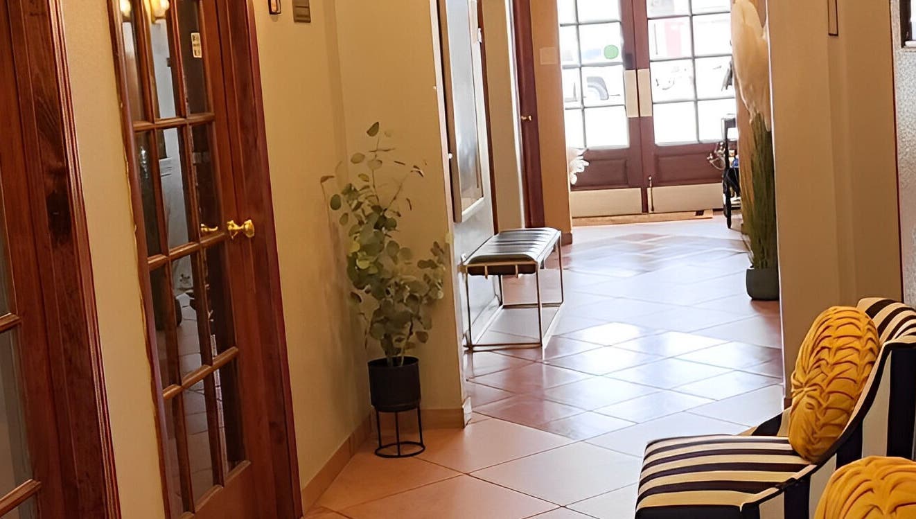 Sophisticated hallway at Ash Did That in Humble, Texas, US, featuring plush seating and stylish decor.