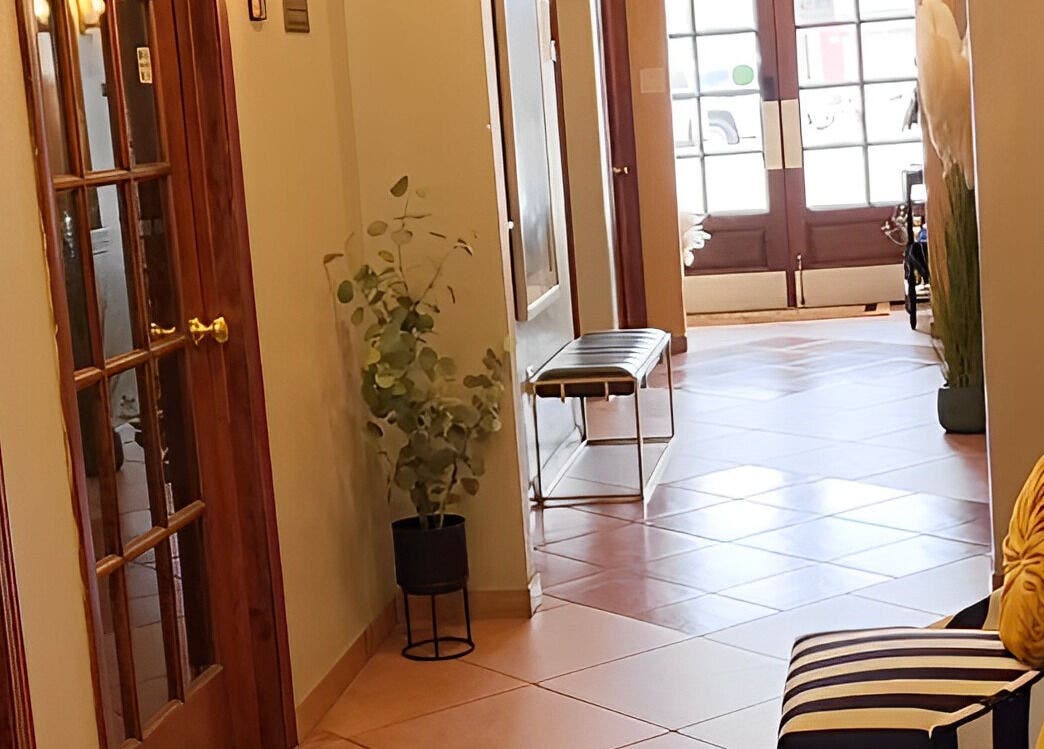 Sophisticated hallway at Ash Did That in Humble, Texas, US, featuring plush seating and stylish decor.