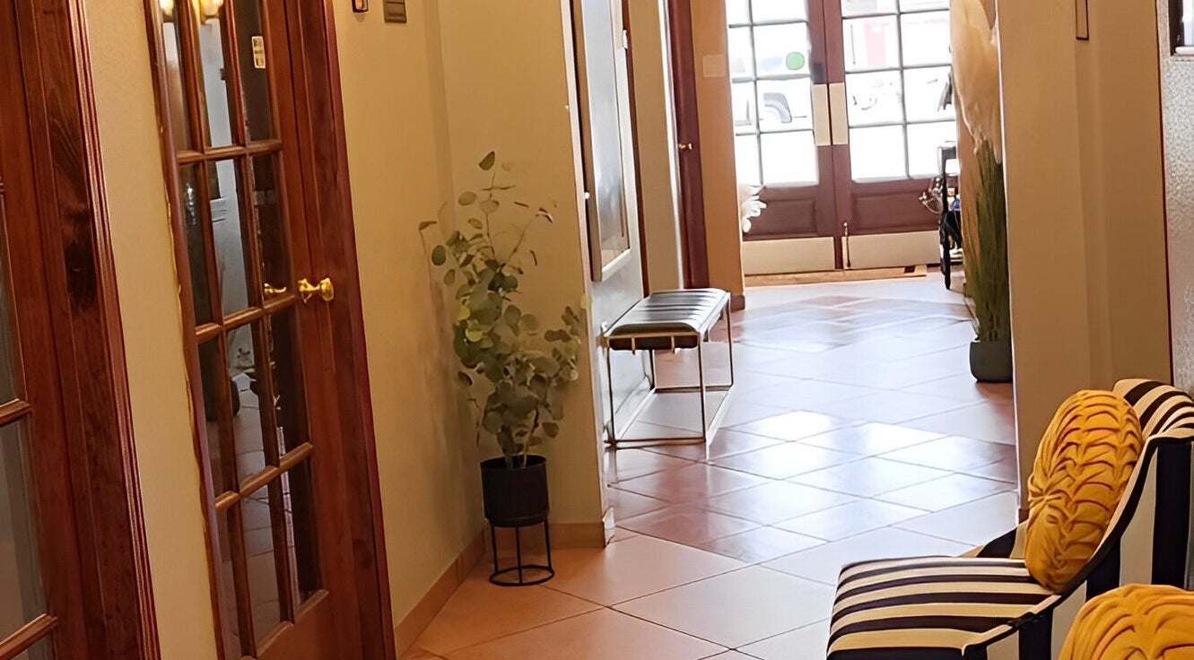 Sophisticated hallway at Ash Did That in Humble, Texas, US, featuring plush seating and stylish decor.