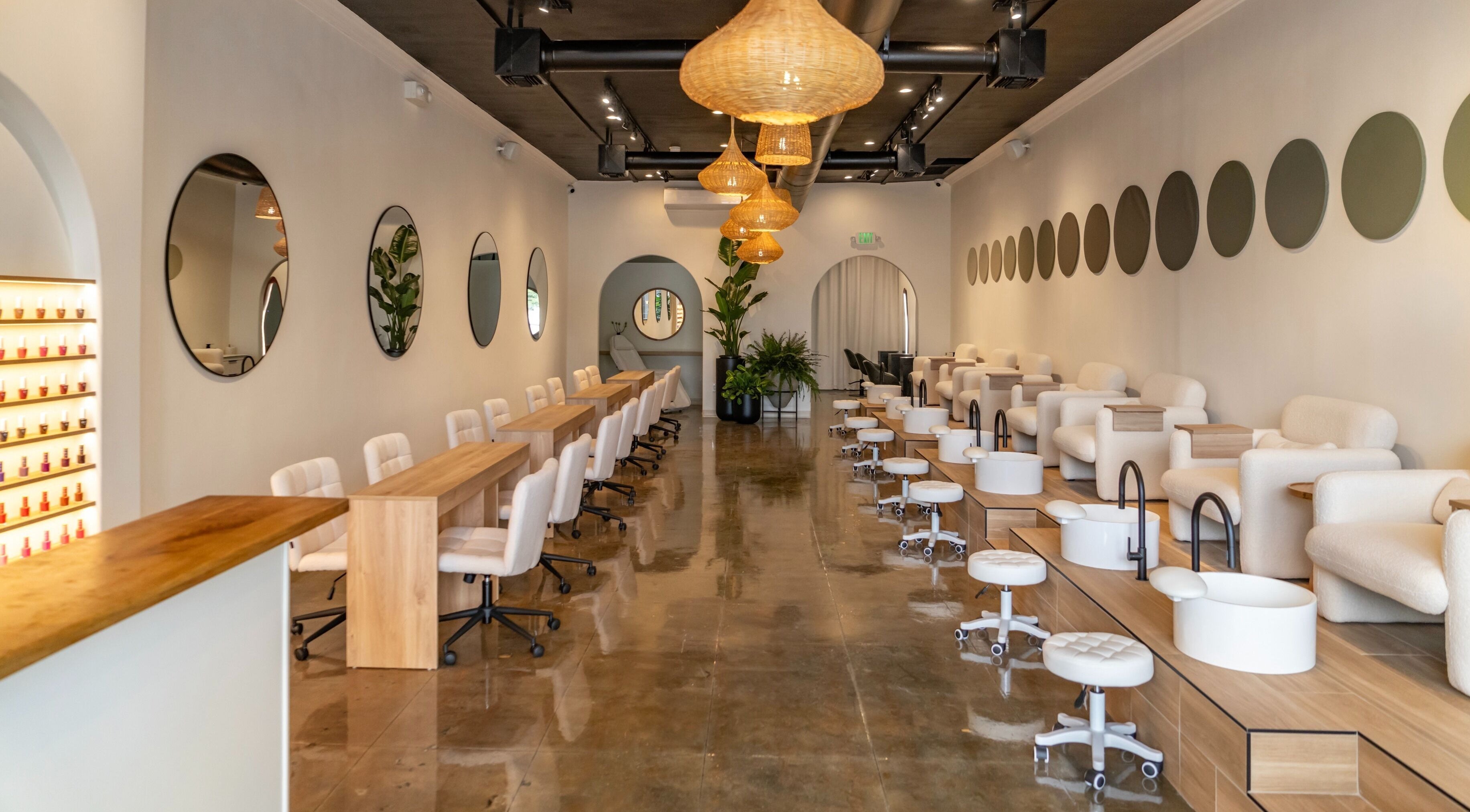 Interior view of Charme Nails & Beauty featuring modern decor and seating in Los Angeles, California, US.