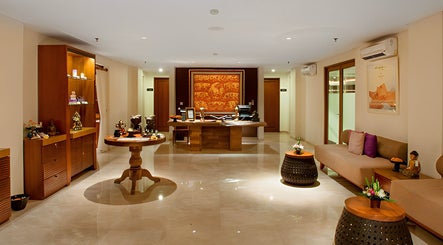 Elegant lobby at Visala Spa The Magani, Bali, featuring wooden decor and cozy seating.