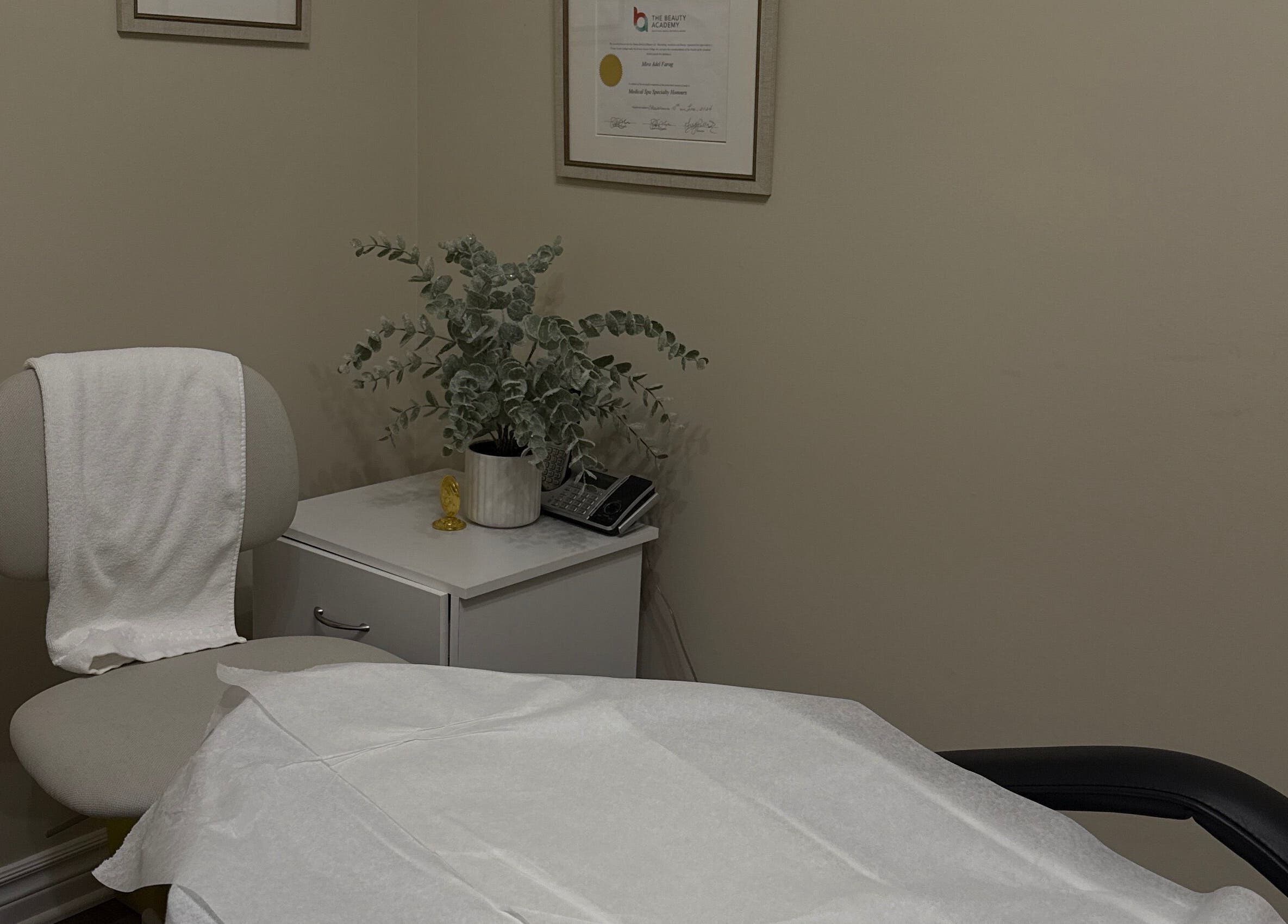 Cozy treatment room at Mira beauty in Ottawa, Ontario, CA, featuring a chair, greenery, and relaxing ambiance.