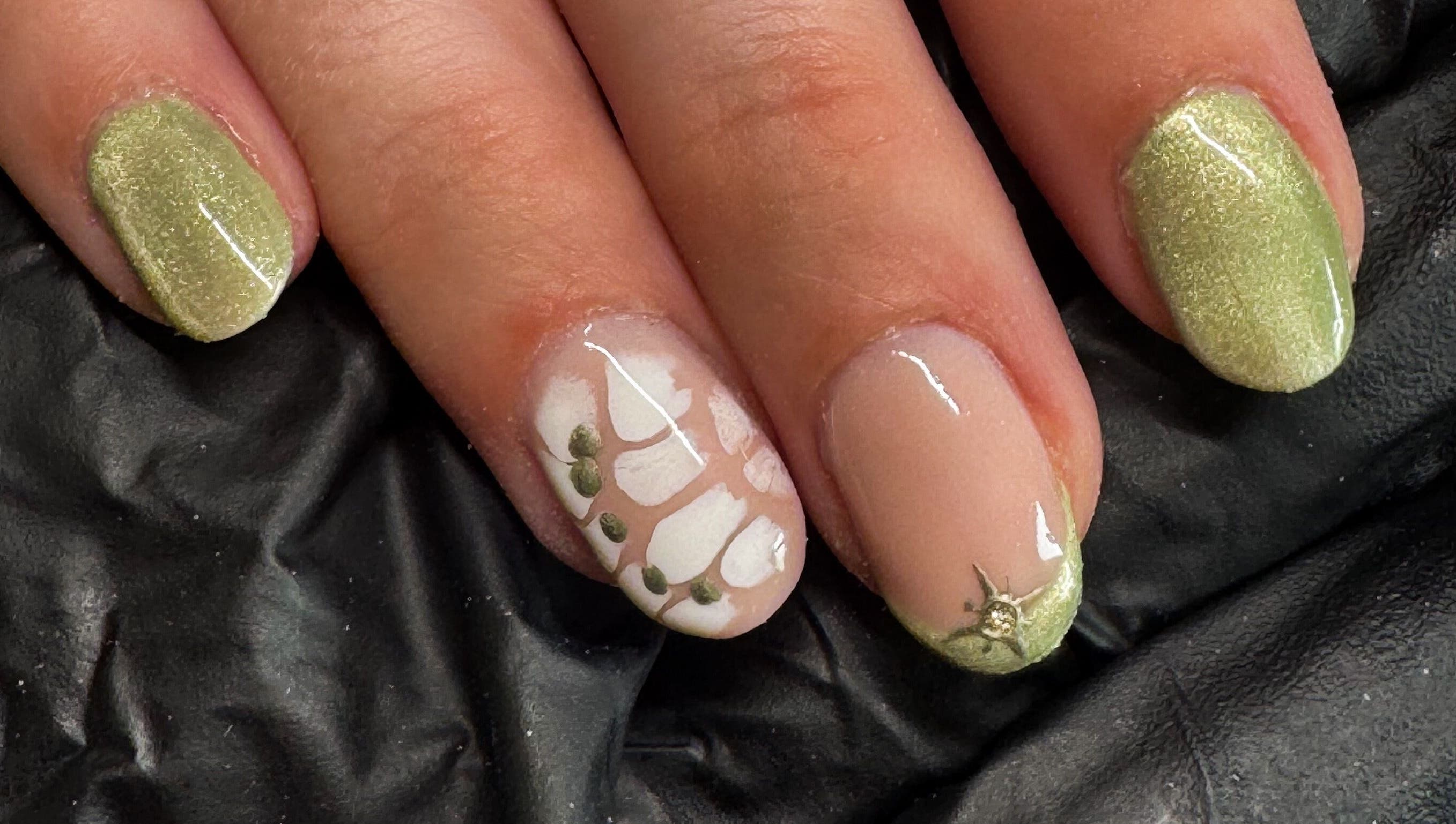 Stylish green and white nail art at Studio Gelle, Standish, England, GB featuring intricate detailing.