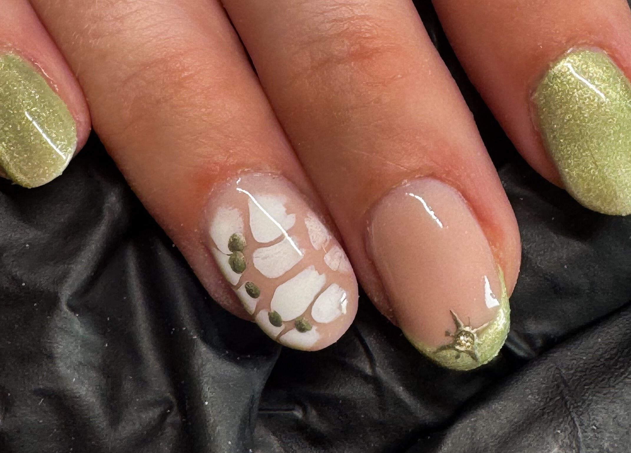 Stylish green and white nail art at Studio Gelle, Standish, England, GB featuring intricate detailing.