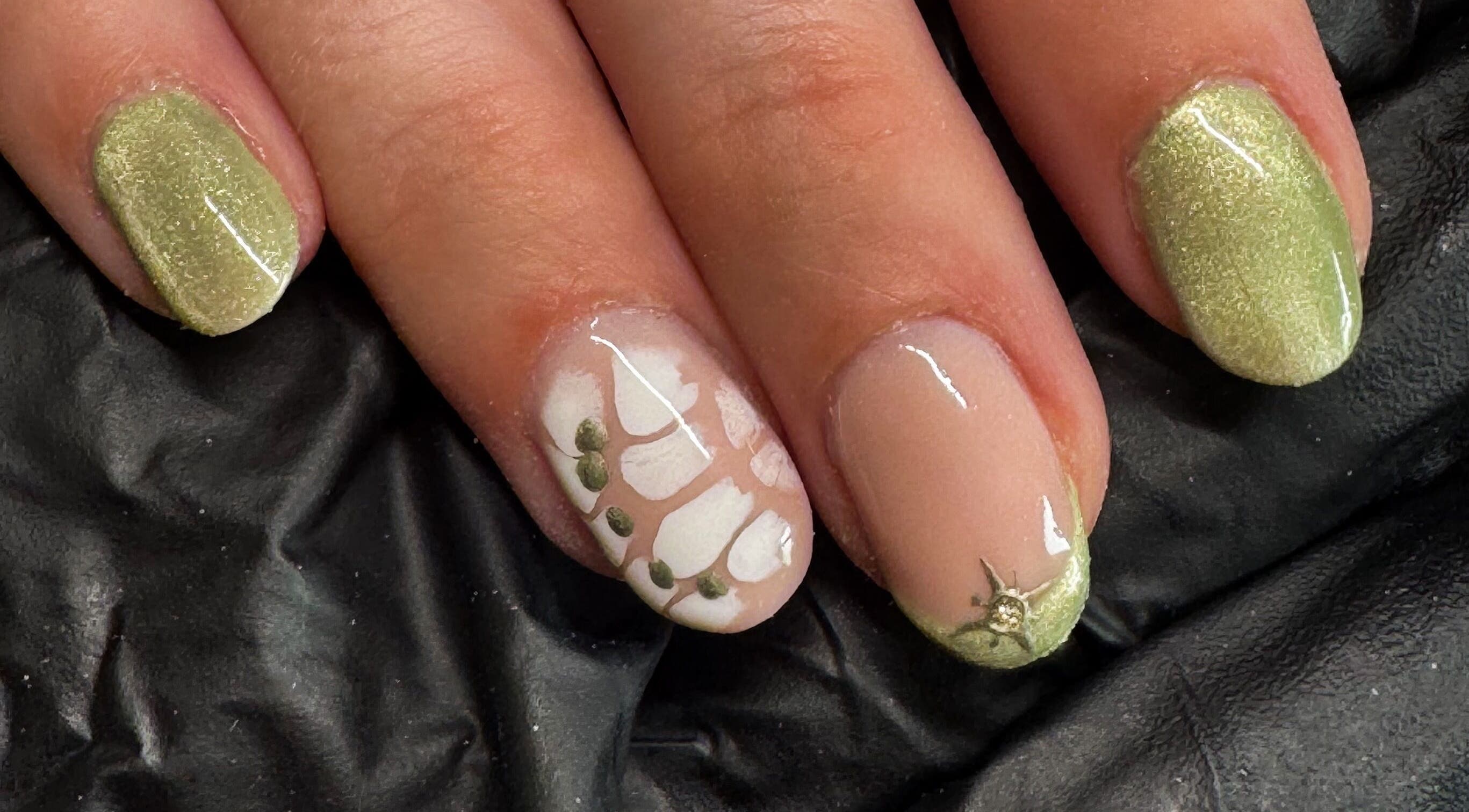 Stylish green and white nail art at Studio Gelle, Standish, England, GB featuring intricate detailing.