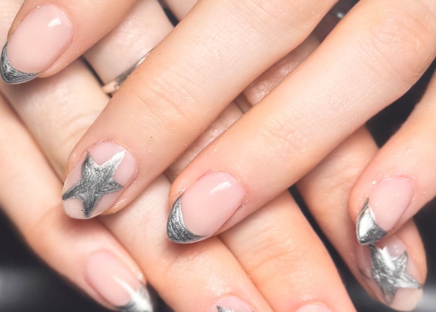 Nail art featuring silver stars at Studio Gelle, Standish, England, GB.