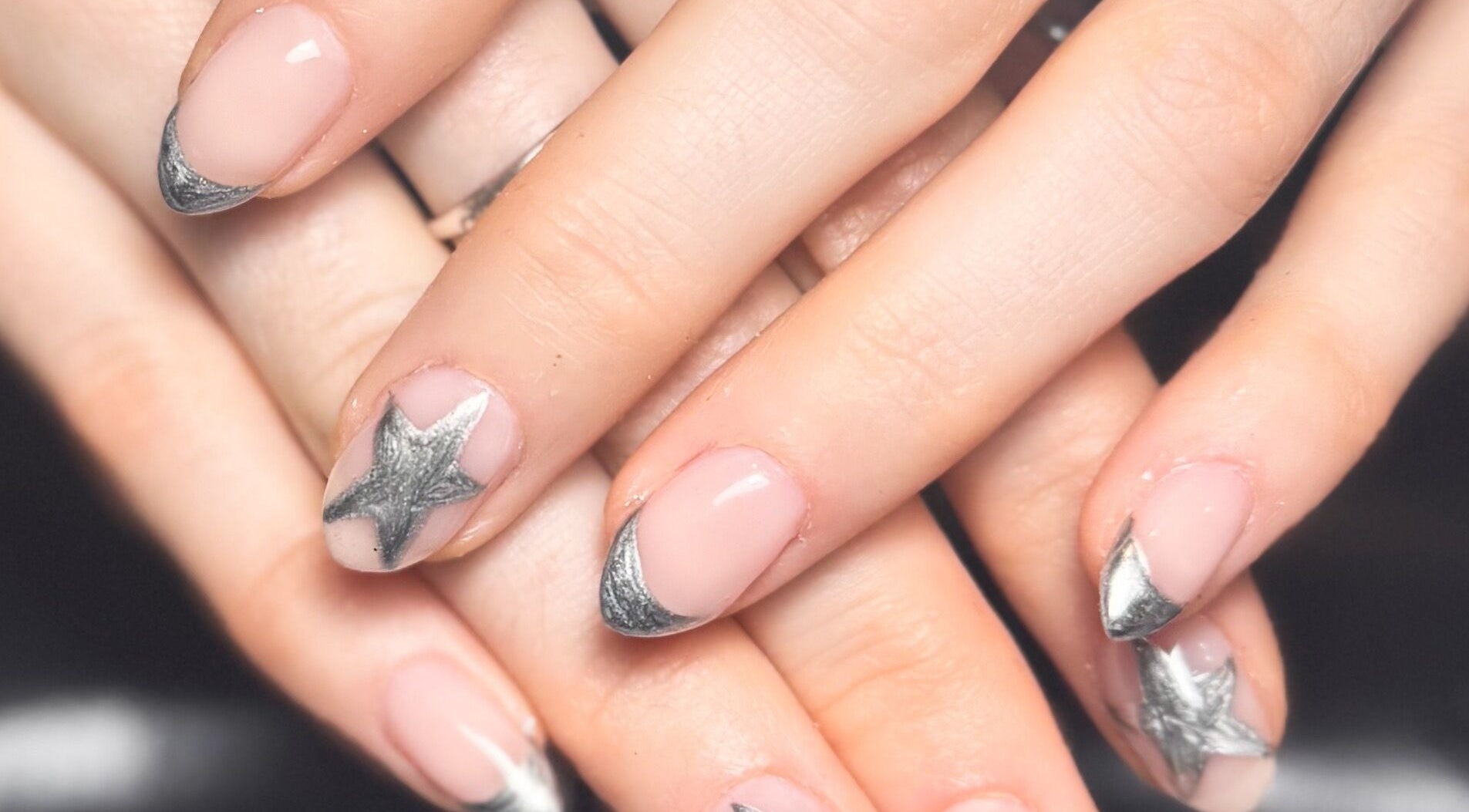 Nail art featuring silver stars at Studio Gelle, Standish, England, GB.