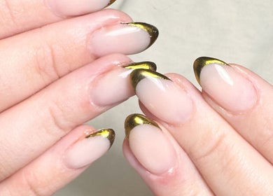 Elegant gold-tipped manicure at Studio Gelle in Standish, England, GB, showcasing professional nail artistry.