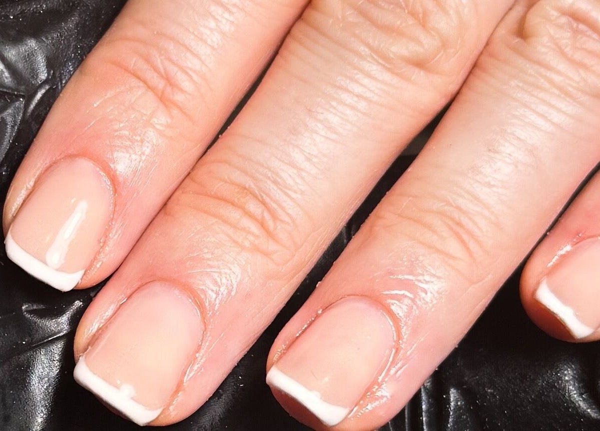 Beautiful French manicure at Studio Gelle, Standish, England, GB, showcasing sleek and elegant nail design.