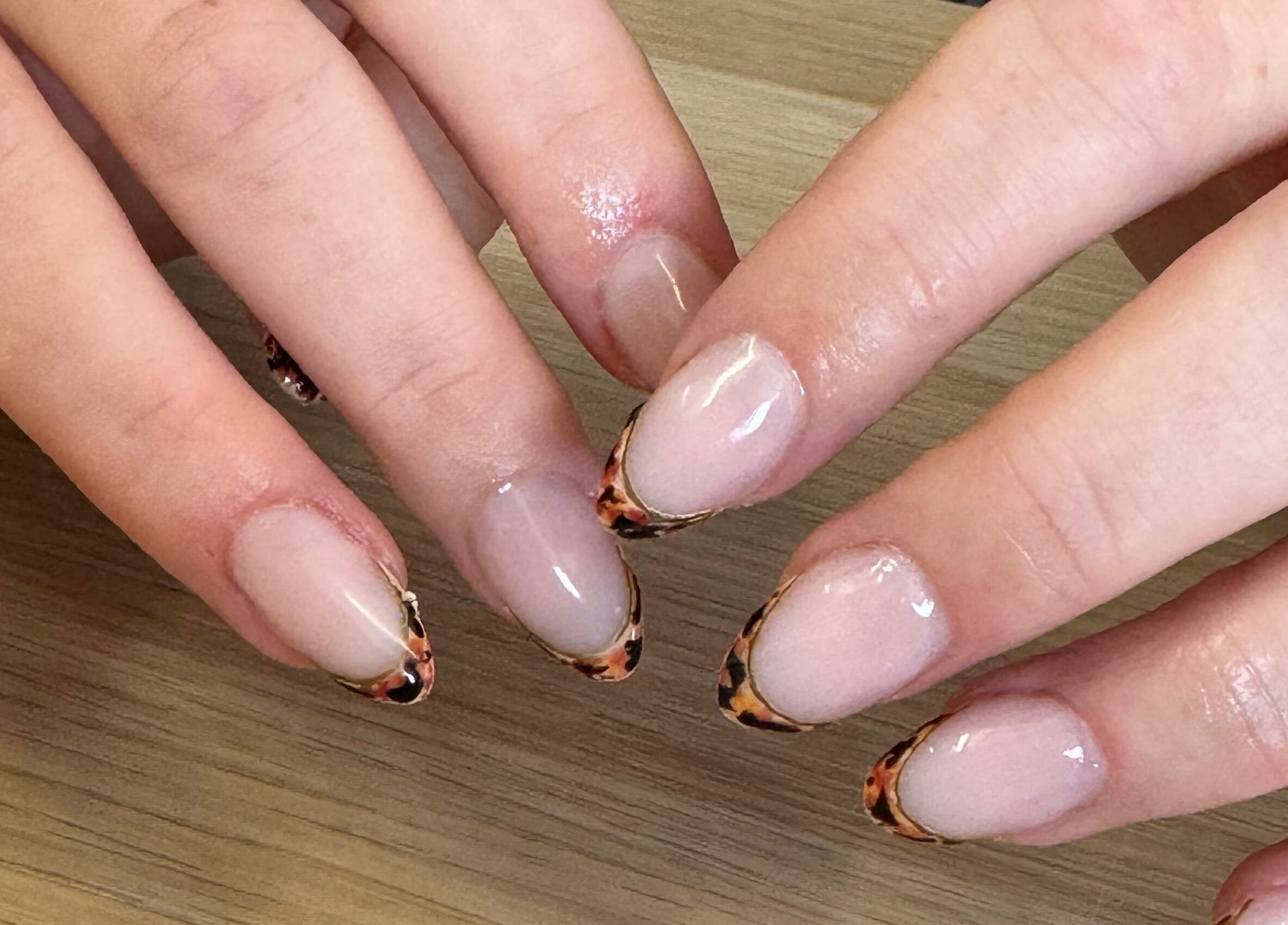 Stylish nails with leopard tips at Studio Gelle, Standish, England, GB, showcasing expert manicure work.