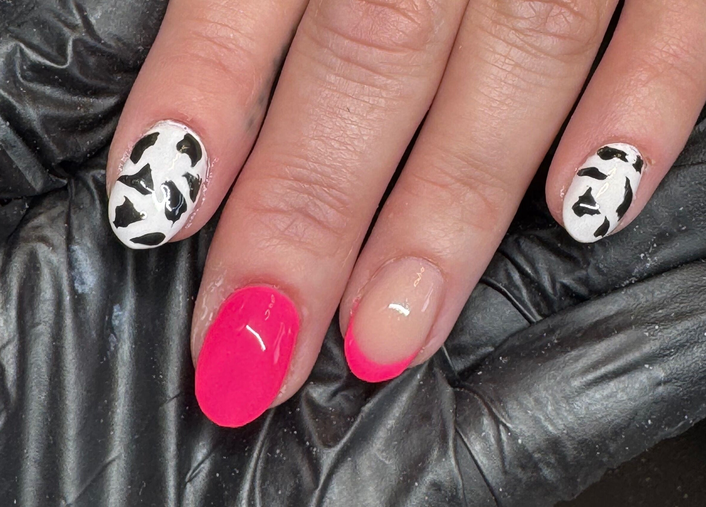 Unique cow print nail art with pink accents at Studio Gelle, Standish, England, GB.