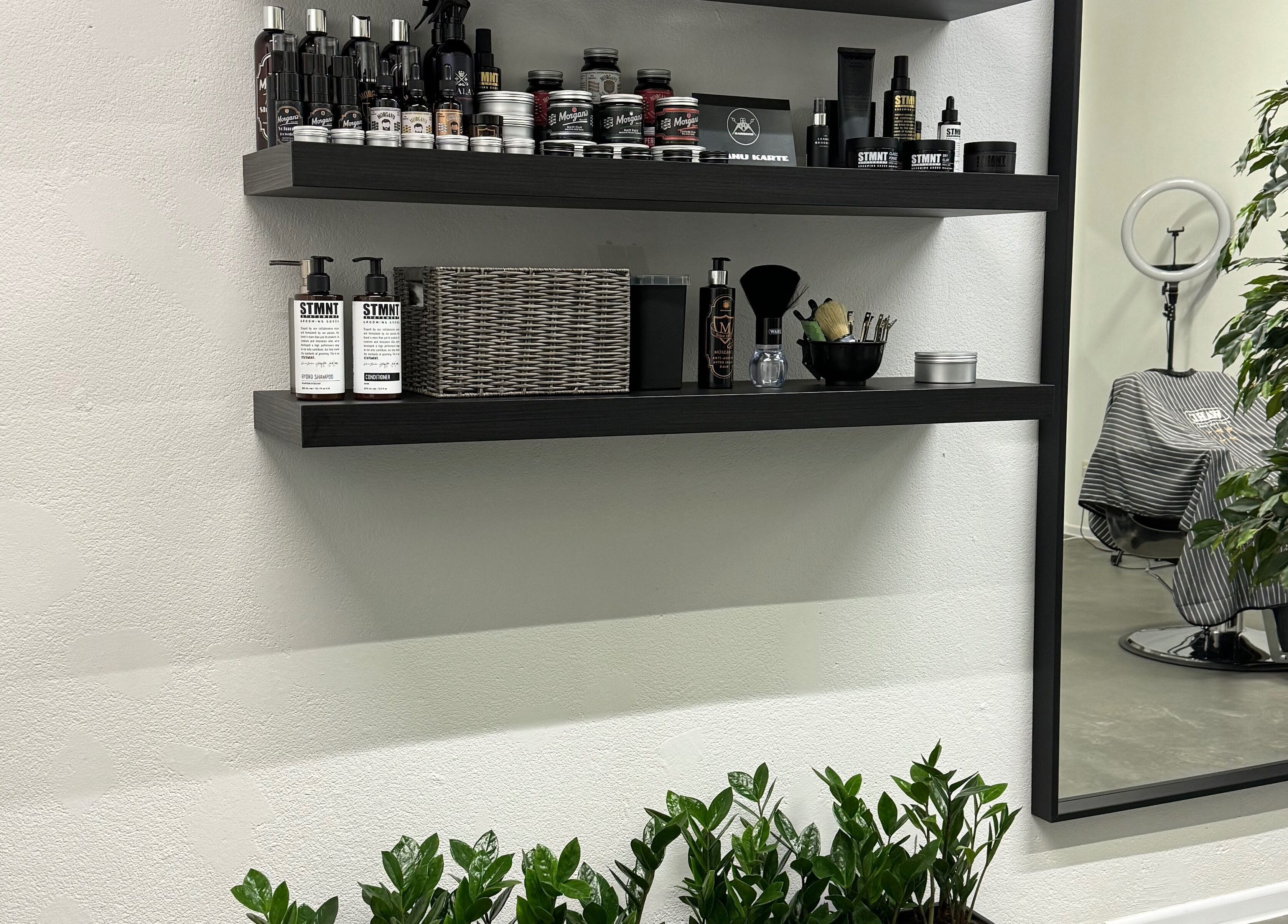 MAD BARBERS in Jelgava, LV displays stylish shelves with grooming products and a modern barber chair.