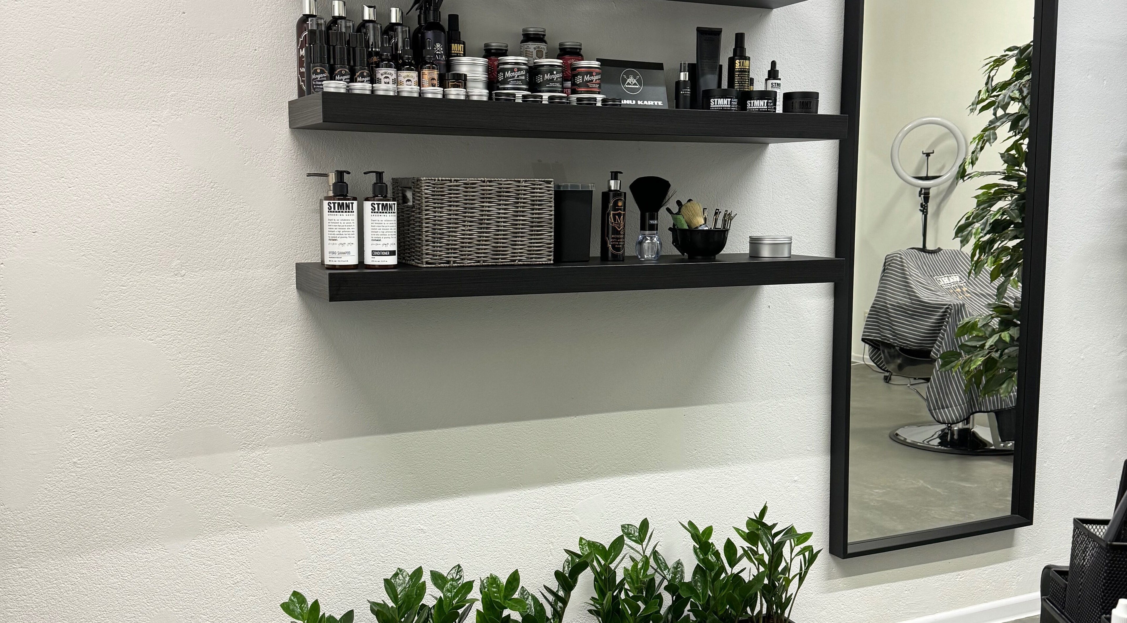 MAD BARBERS in Jelgava, LV displays stylish shelves with grooming products and a modern barber chair.