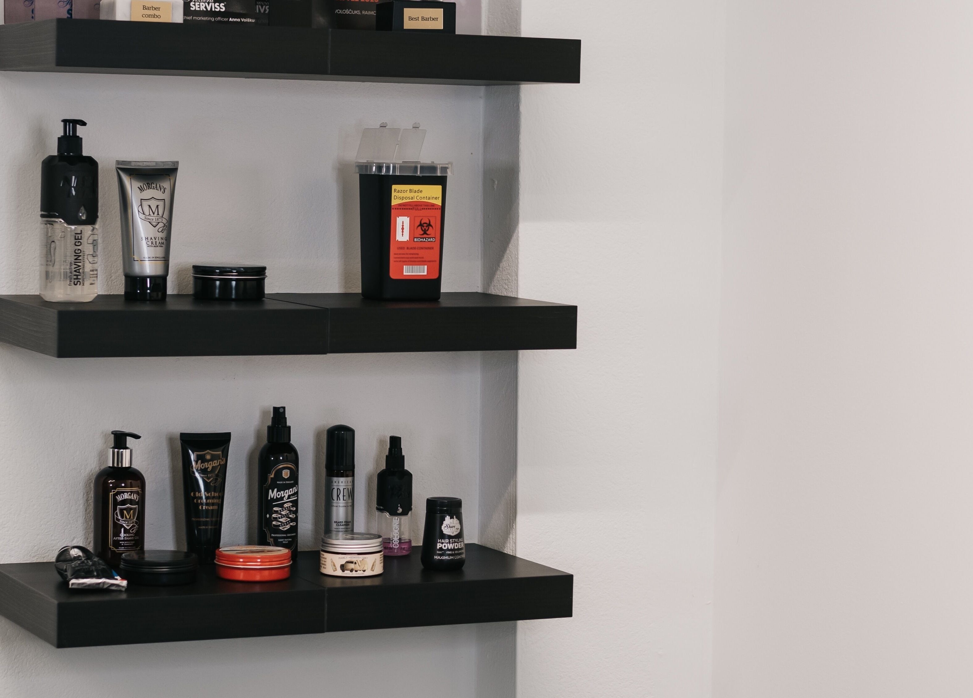 Barber products on shelves at MAD BARBERS, Jelgava, LV, showcasing premium grooming items.