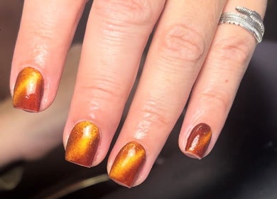Vibrant golden nails at Juicy Beauty, Gateshead, England, GB. Stunning manicure showcasing brilliant shine.