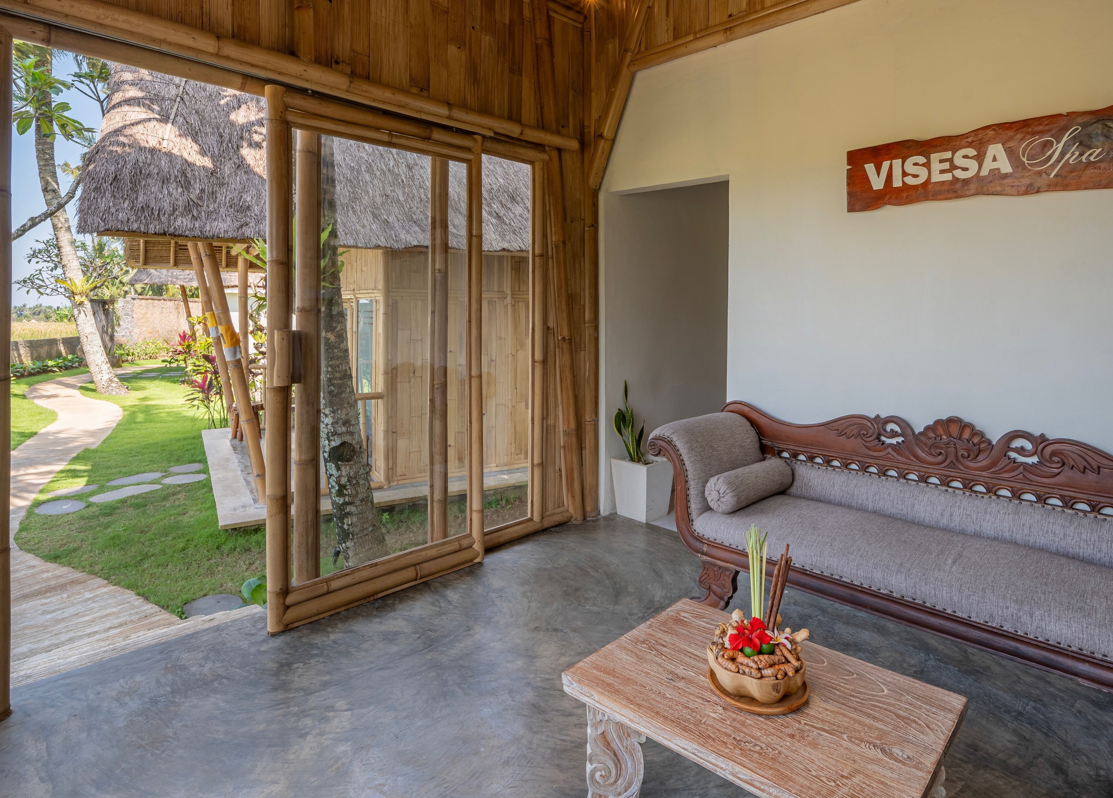 Relaxing lounge at Visesa Spa, Bali, Bali, ID with lush garden view and elegant decor.