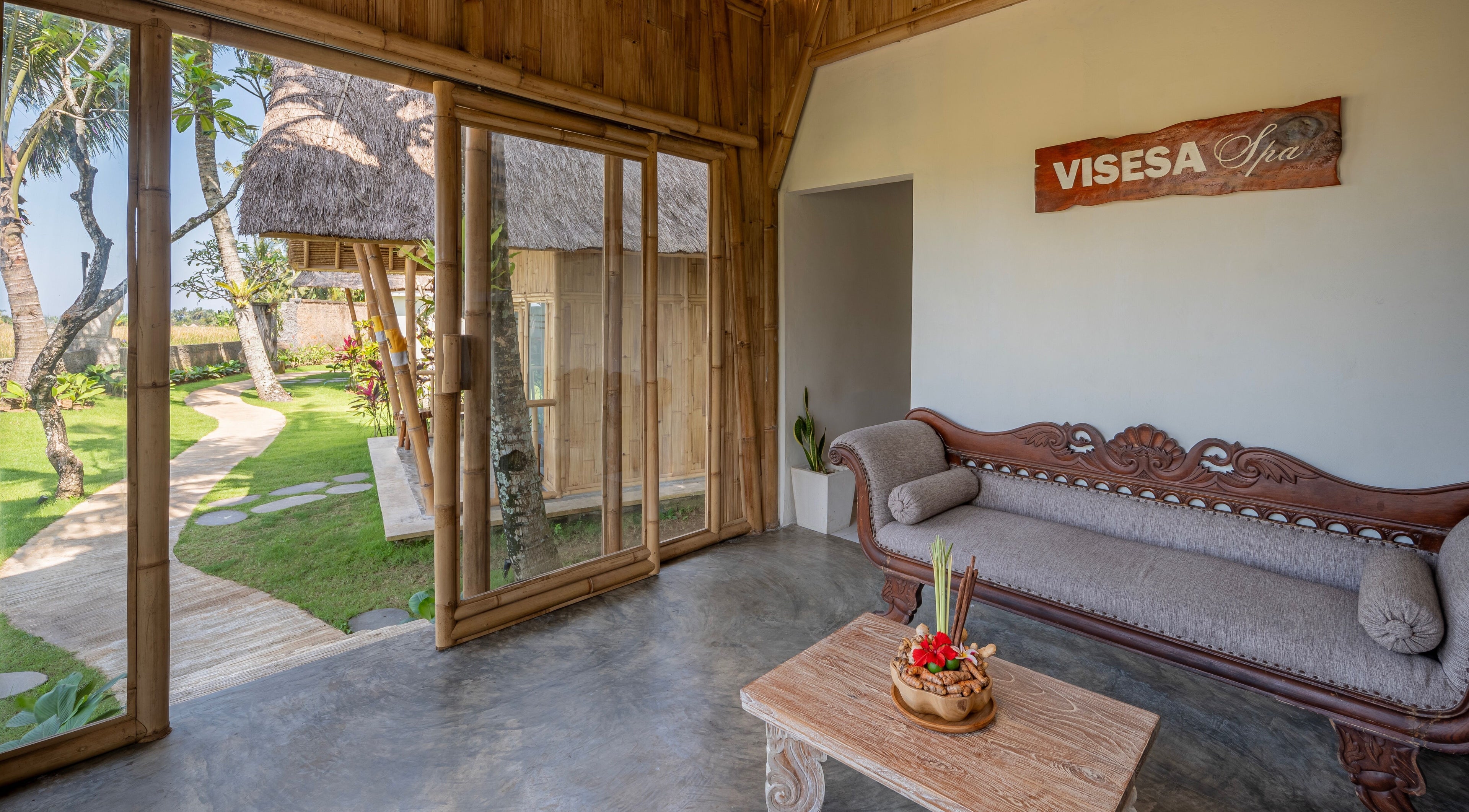 Relaxing lounge at Visesa Spa, Bali, Bali, ID with lush garden view and elegant decor.