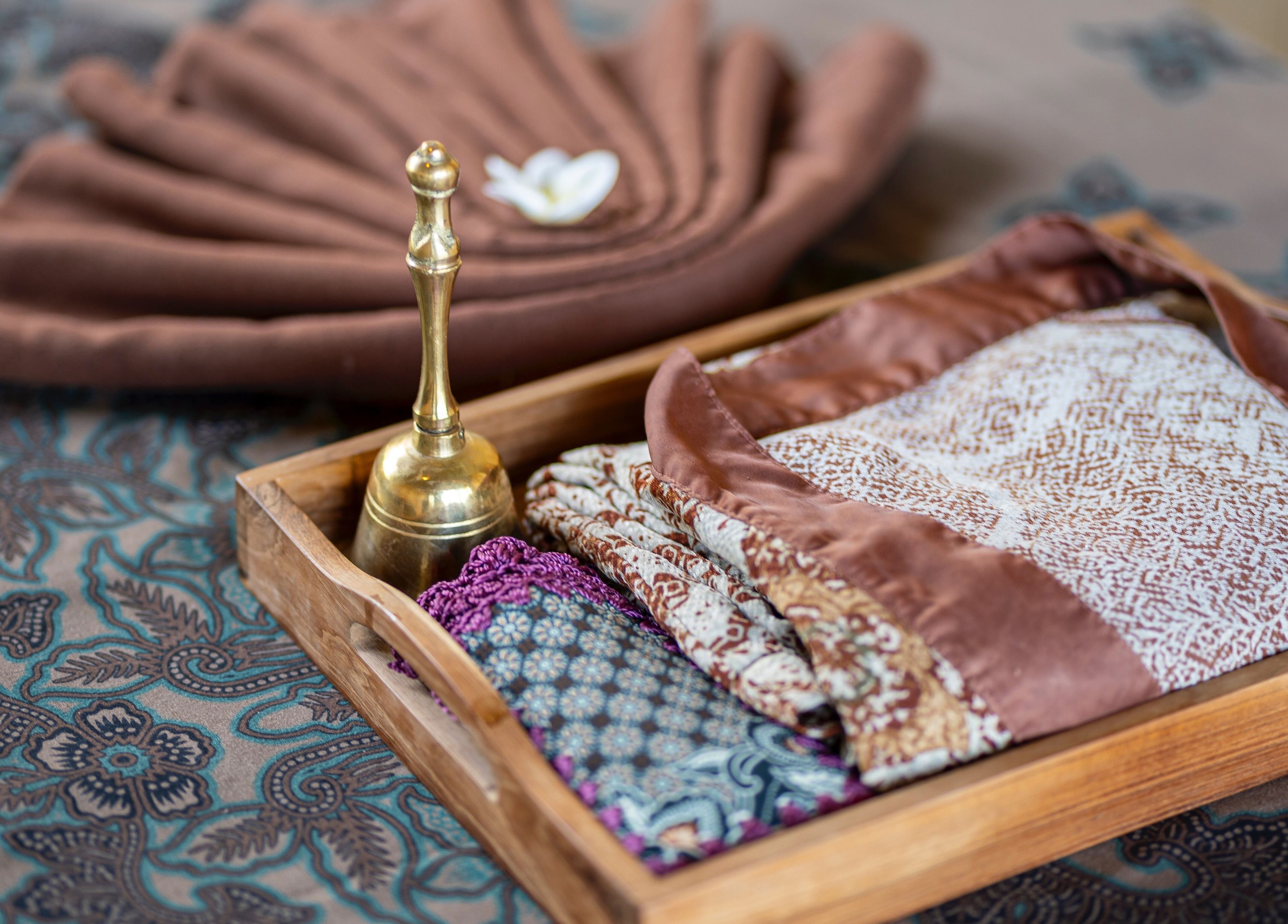 Luxury spa textiles and bell on a tray at Visesa Spa, Bali, Bali, ID, showcasing elegant relaxation.