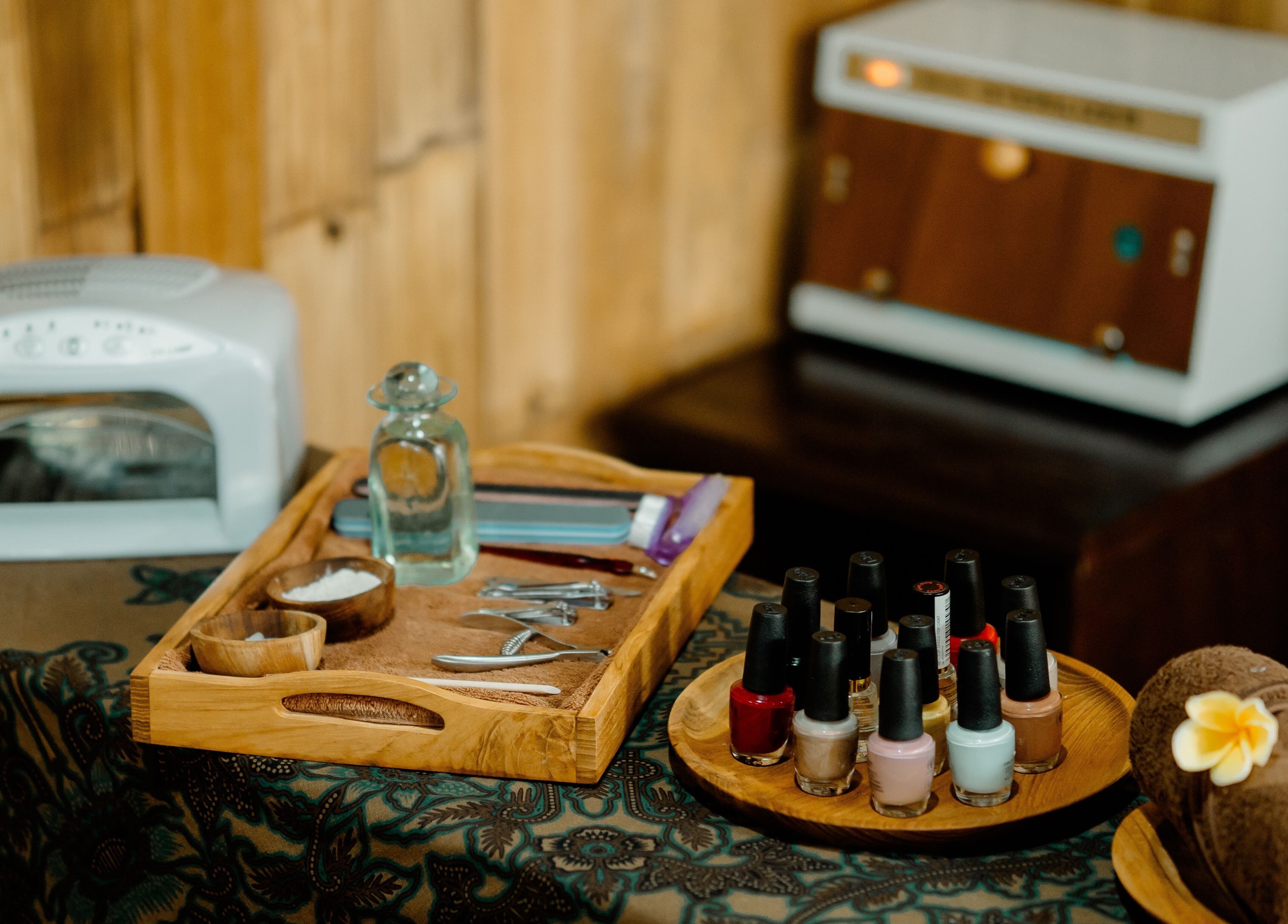 A manicure setup at Visesa Spa, Bali, Bali, ID with nail polish, tools, and towels.
