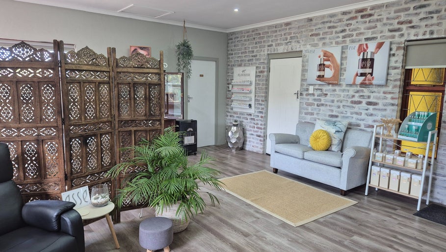 Cozy interior of Flourish Skincare and Beauty Studio in Gqeberha, Eastern Cape, ZA with elegant décor and seating.