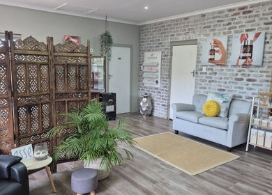 Cozy interior of Flourish Skincare and Beauty Studio in Gqeberha, Eastern Cape, ZA with elegant décor and seating.