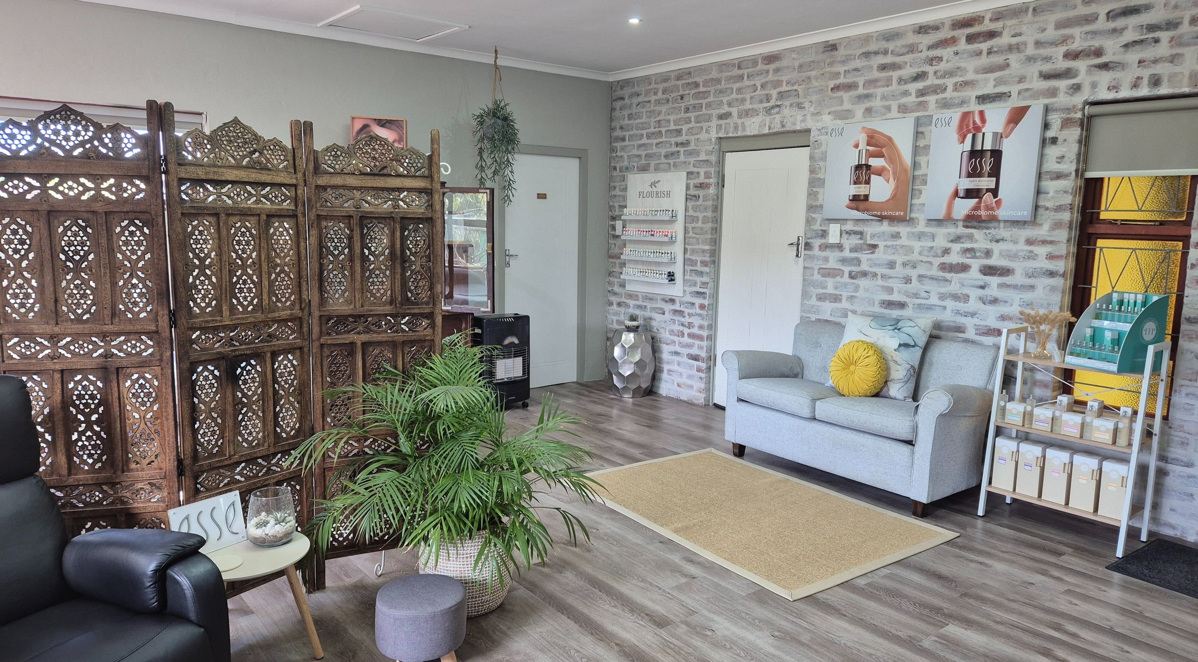 Cozy interior of Flourish Skincare and Beauty Studio in Gqeberha, Eastern Cape, ZA with elegant décor and seating.