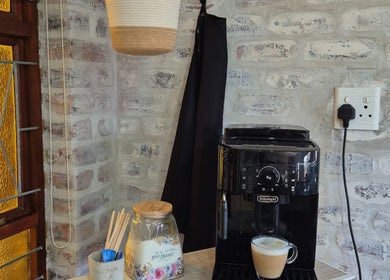 A cozy coffee corner at Flourish Skincare and Beauty Studio in Gqeberha, Eastern Cape, ZA features a coffee machine.