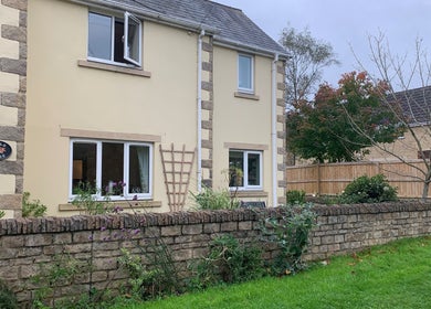 Exterior view of Natalie Jane Wellbeing at Maple House, Malmesbury, England, GB, showcasing greenery and charm.