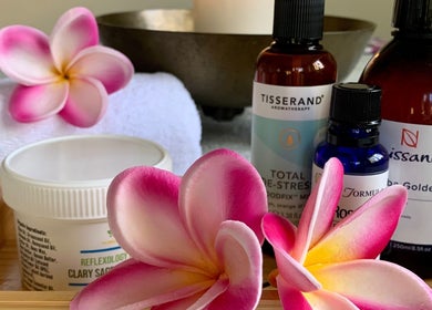 Skincare and aromatherapy products with flowers at Natalie Jane Wellbeing, Malmesbury, England, GB.